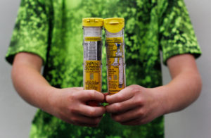 Jack Miller, 10, holds a two-pack of his EpiPen prescription. He has a severe tree nut allergy, and has to keep an EpiPen with him at home, school and in the car at all times. His brother also has severe allergies. His family spends thousands each year to keep multiple packs of EpiPens on hand.